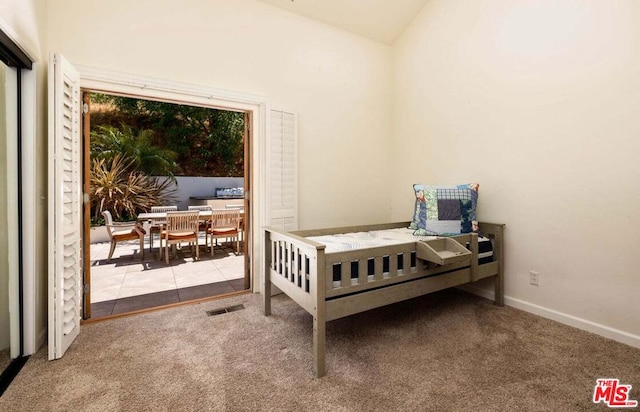 bedroom with lofted ceiling and light carpet