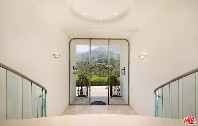 entryway featuring a mountain view and a tray ceiling