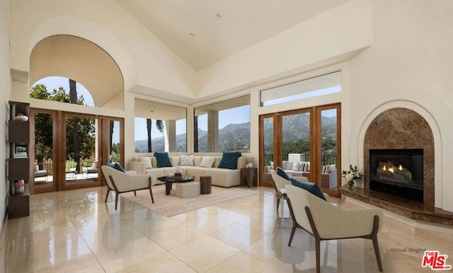 interior space featuring a mountain view, french doors, high vaulted ceiling, and plenty of natural light