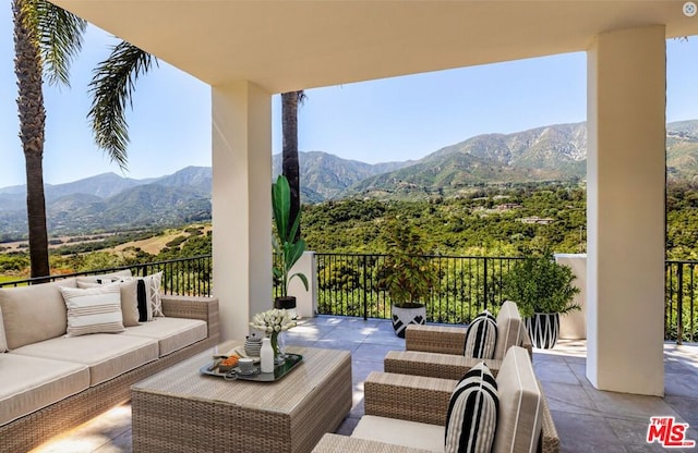 view of patio / terrace featuring a mountain view and an outdoor living space