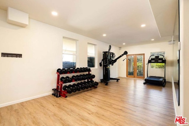 exercise room featuring french doors and light hardwood / wood-style flooring