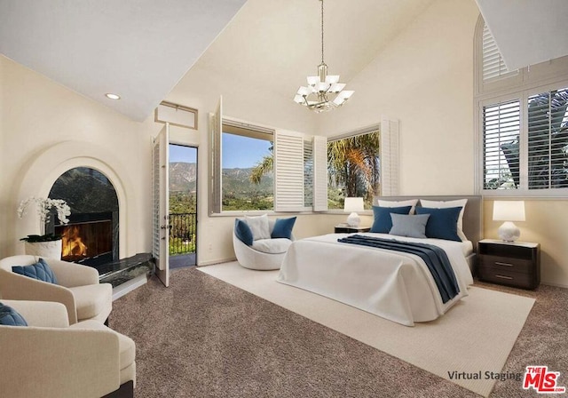 carpeted bedroom featuring access to exterior, high vaulted ceiling, a notable chandelier, and a high end fireplace