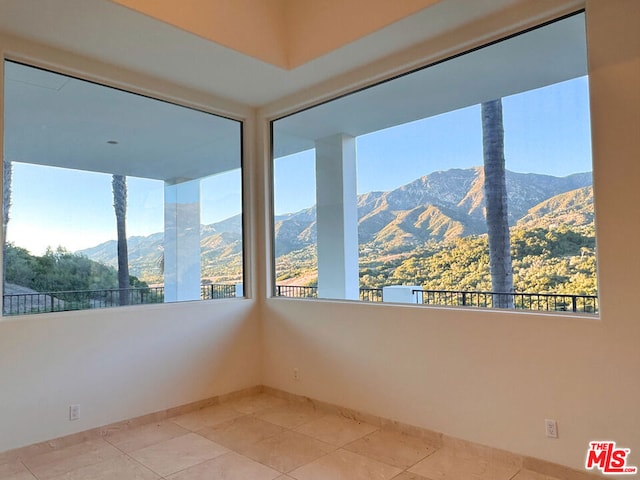 unfurnished sunroom with a mountain view