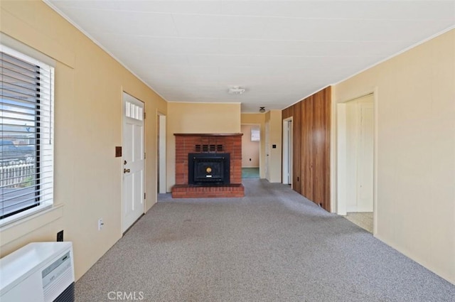 unfurnished living room with an AC wall unit, light carpet, and wooden walls