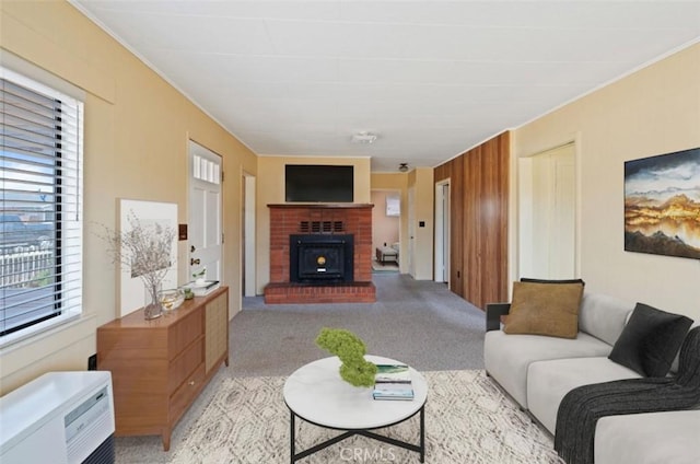 living room featuring a healthy amount of sunlight, wooden walls, and light carpet