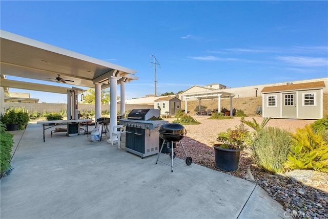 view of patio / terrace with a shed, a grill, a pergola, and ceiling fan