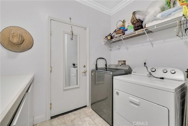 laundry area featuring crown molding and washer and dryer