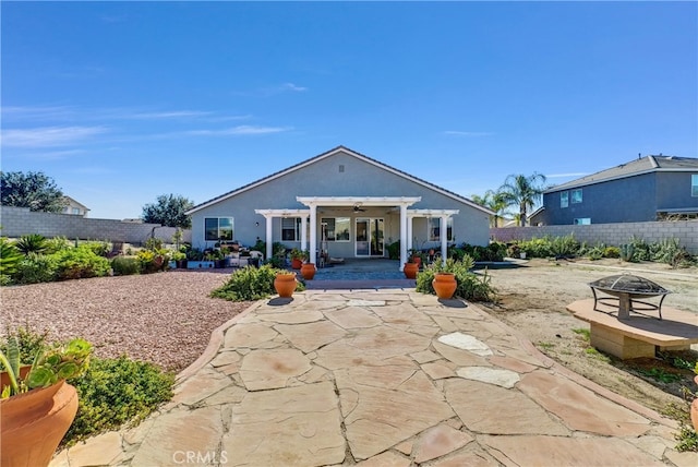 back of house featuring an outdoor fire pit, a pergola, and a patio area