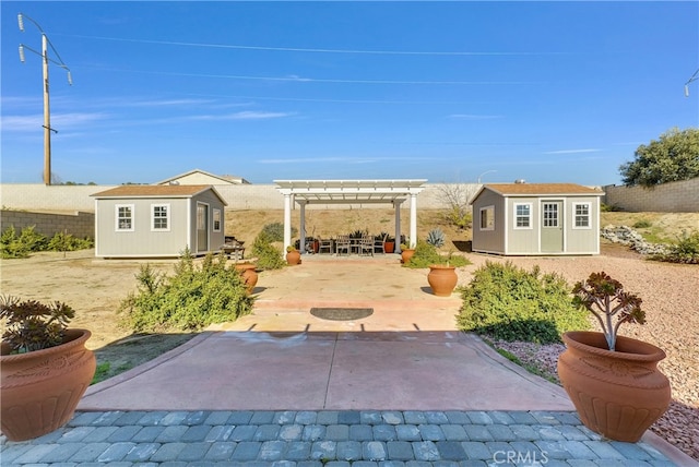 view of patio with a storage unit and a pergola