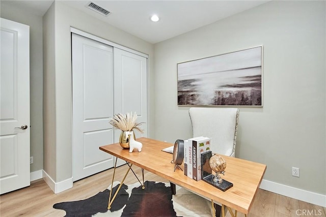 office with light wood-style floors, recessed lighting, visible vents, and baseboards