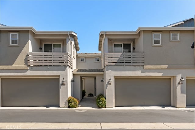 multi unit property featuring a balcony and a garage