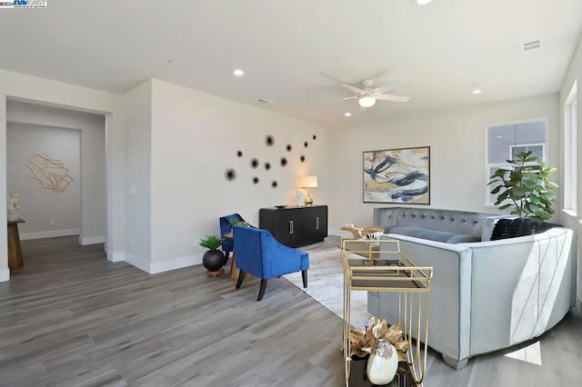 living room with hardwood / wood-style floors and ceiling fan