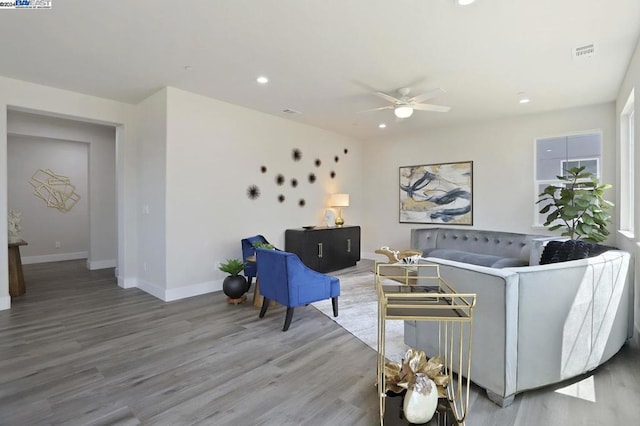 living room with hardwood / wood-style flooring and ceiling fan