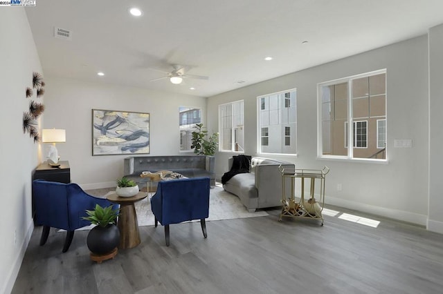 living area with ceiling fan and light wood-type flooring