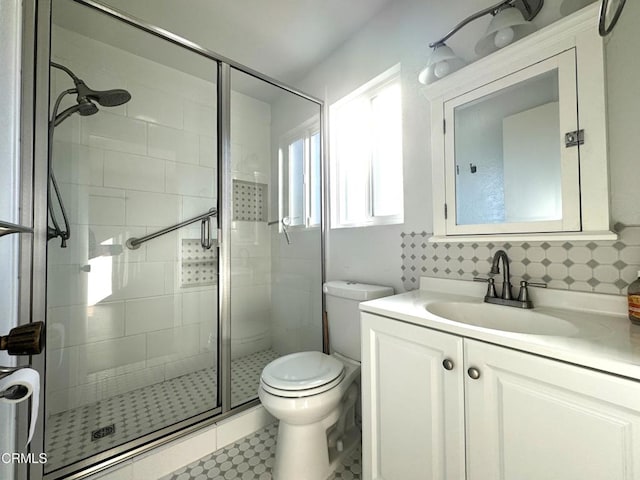 bathroom with toilet, backsplash, tile walls, vanity, and walk in shower