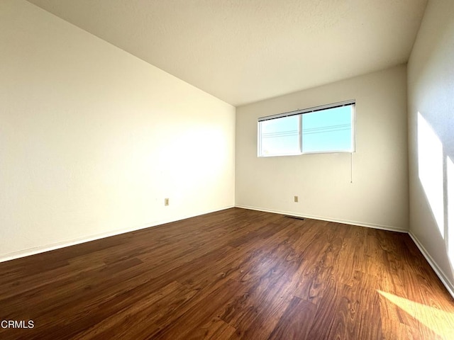 spare room featuring dark hardwood / wood-style flooring