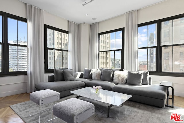 living room featuring a wealth of natural light and parquet floors