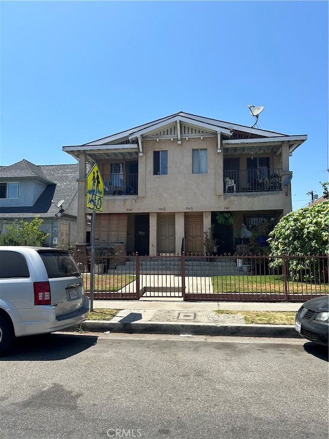 view of front of house with a balcony