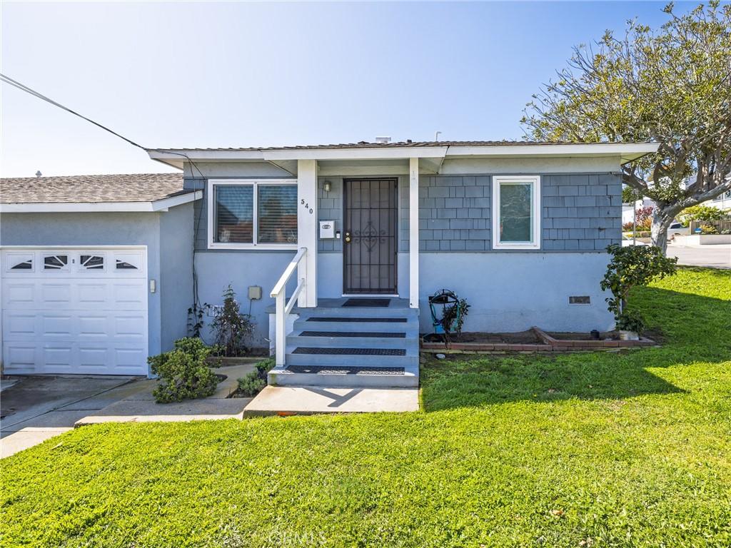 536 W Maple Ave, El Segundo, CA 90245 - view of front of property with stucco siding, concrete driveway, a front lawn, and a garage