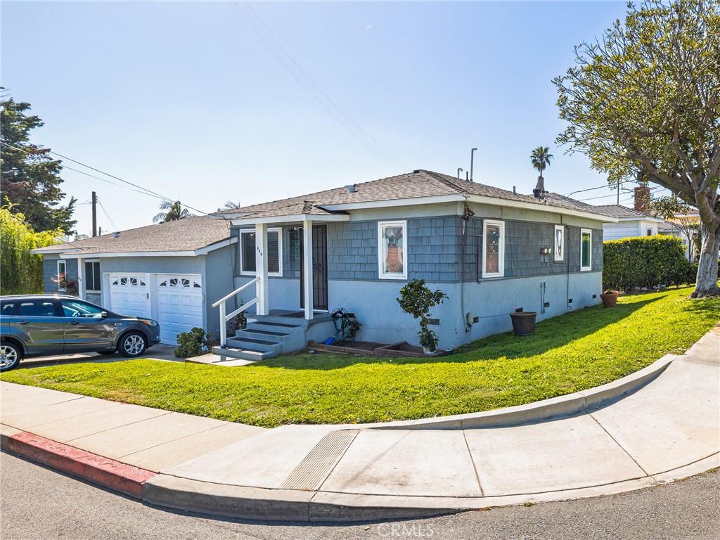 536 W Maple Ave, El Segundo, CA 90245 - view of front of house with a front lawn, a shingled roof, and an attached garage
