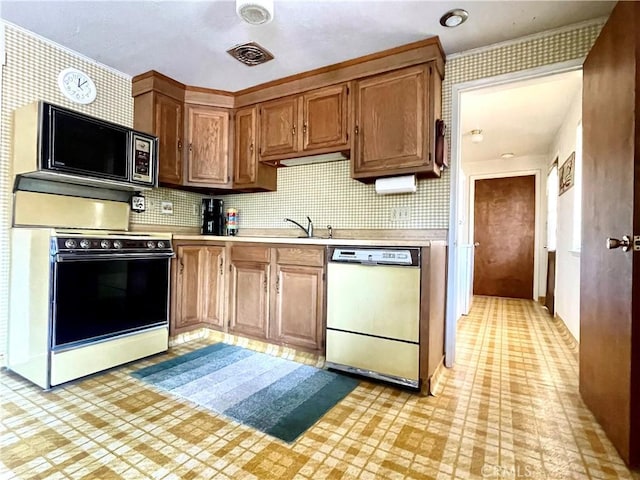 kitchen with backsplash, stainless steel appliances, and sink