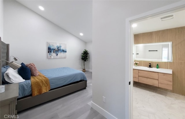 bedroom featuring light hardwood / wood-style floors and lofted ceiling