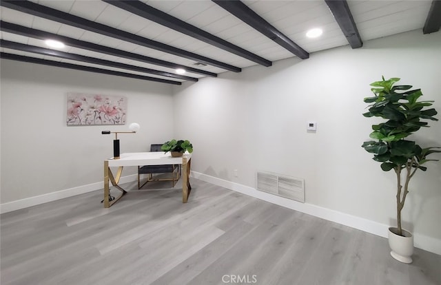 office area featuring light hardwood / wood-style flooring and beam ceiling