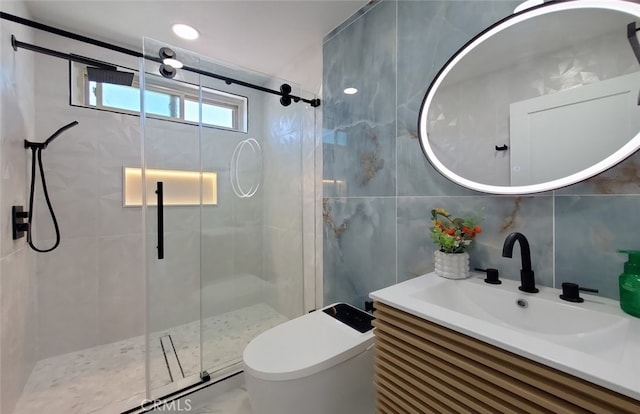 bathroom with tile walls, backsplash, a shower with door, vanity, and toilet