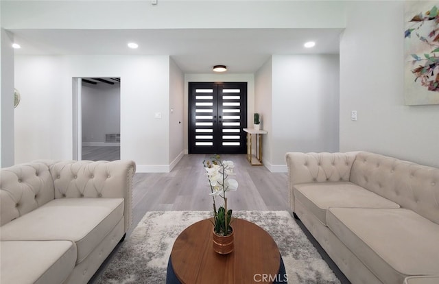 living room featuring light wood-type flooring and french doors