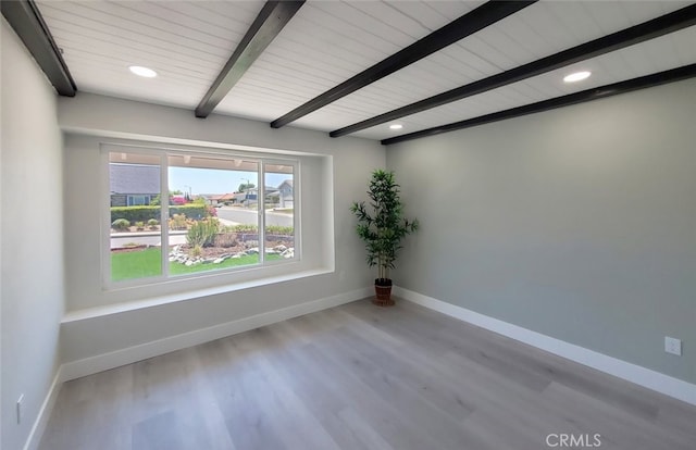 spare room featuring wood ceiling, beamed ceiling, and light hardwood / wood-style flooring