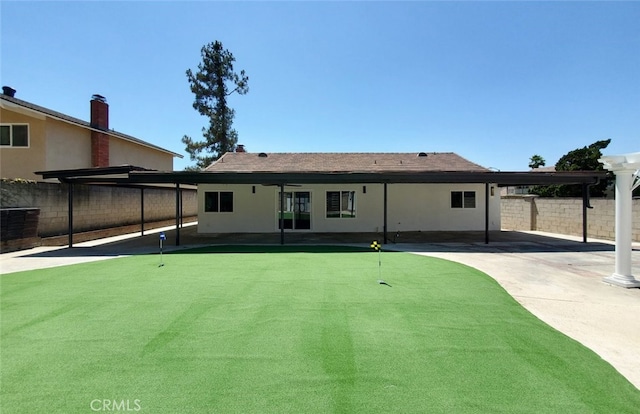 back of house with cooling unit, a patio area, and a carport