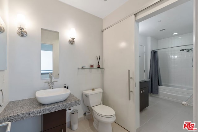 full bathroom featuring tile patterned floors, shower / bath combination with curtain, vanity, and toilet