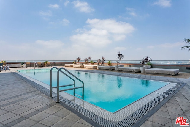 view of swimming pool with a patio