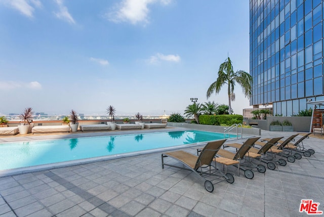 view of swimming pool with a patio area