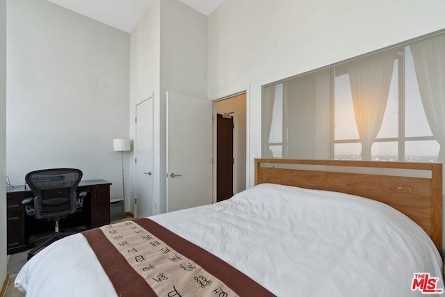 bedroom with high vaulted ceiling