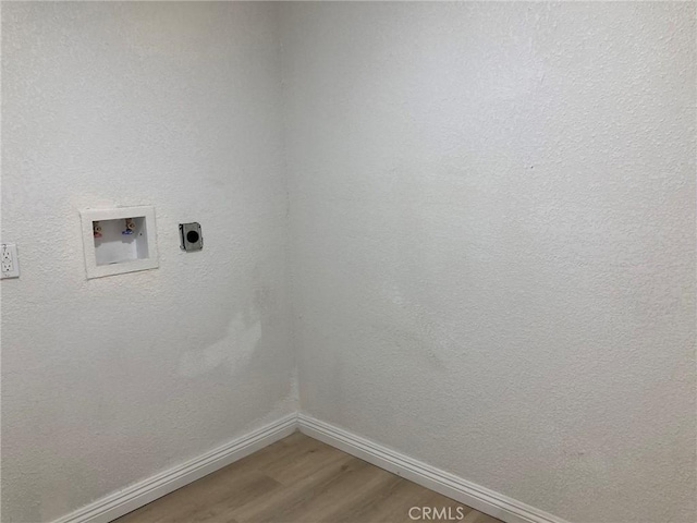 laundry area featuring electric dryer hookup, washer hookup, and hardwood / wood-style flooring