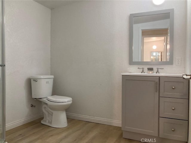 bathroom featuring hardwood / wood-style floors, vanity, and toilet