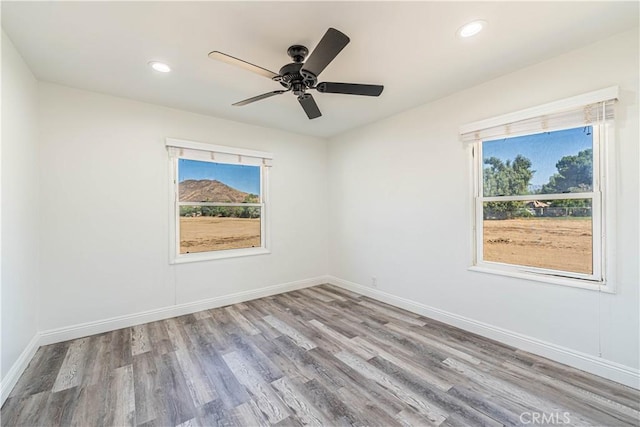 unfurnished room featuring light wood-type flooring and ceiling fan