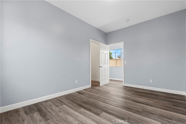 spare room featuring wood-type flooring