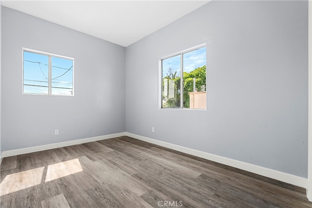 spare room with wood-type flooring