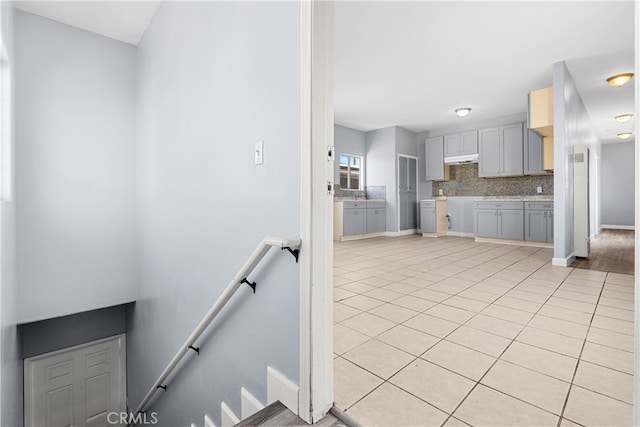 staircase featuring light tile patterned flooring