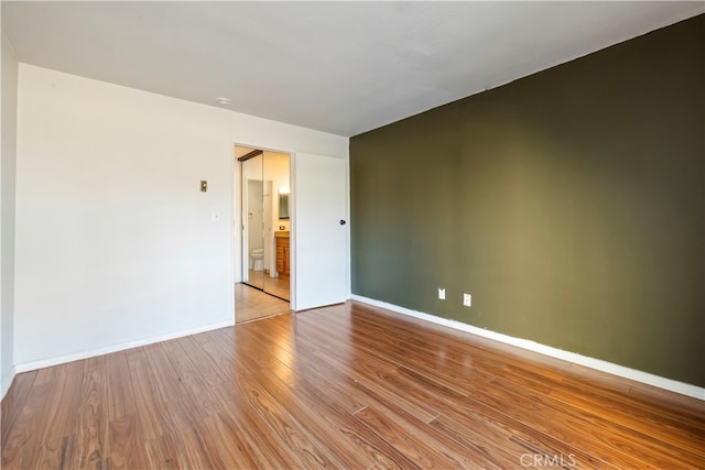 unfurnished room with light wood-type flooring