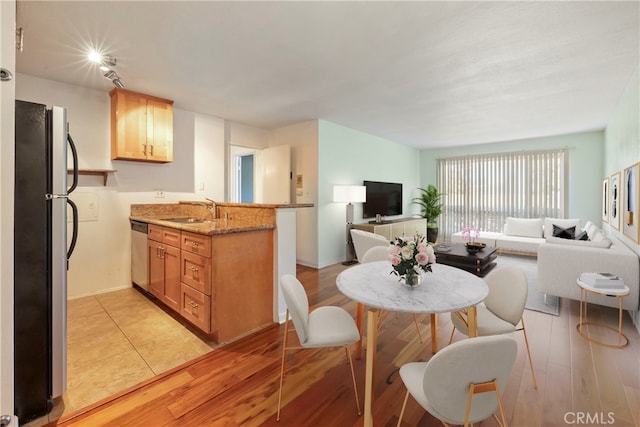 dining area featuring light hardwood / wood-style flooring and sink