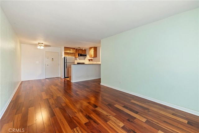 unfurnished living room featuring dark hardwood / wood-style flooring