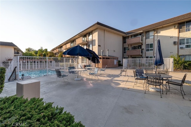 view of swimming pool with a jacuzzi and a patio