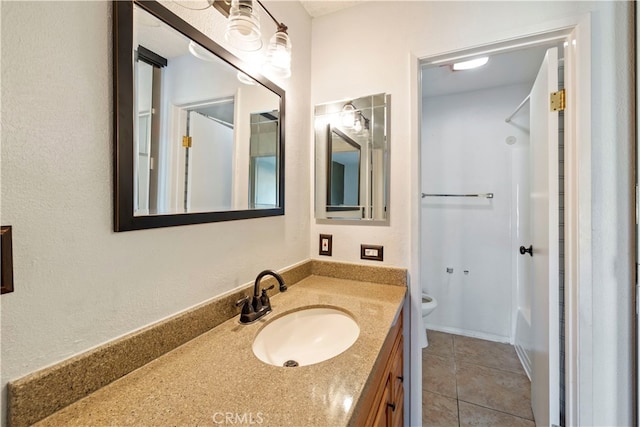 bathroom with tile patterned floors, vanity, and toilet