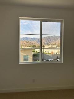 unfurnished room featuring a mountain view