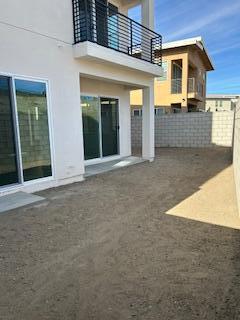 back of house featuring a balcony