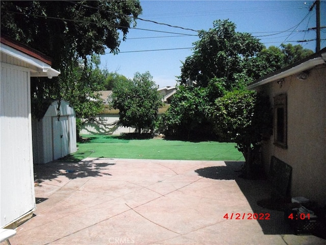 view of patio / terrace with an outbuilding