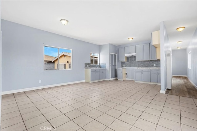 10406 Avalon Blvd, Los Angeles, CA 90003 - kitchen with gray cabinets, backsplash, and light tile patterned floors